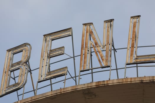 Madrid, Spain - May 19, 2020: The old rusty sign of the Benlliure cinemas, located on the roof of a building, on Alcala street, in the Retiro district.