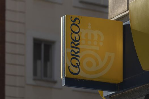 Madrid, Spain - May 19, 2020: The entrance sign to a post office on Calle Ibiza, in the Retiro district. They offer parcel, collection, shipping and other national and international services.