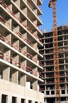 Composition of modern construction closeup with building wall and crane