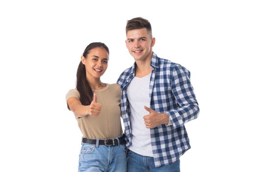 Happy couple of young people shuwing thumb up gesture, love excited smiling looking at camera, isolated on white background, casual people