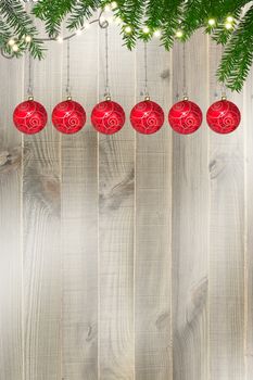 Christmas greeting card on wooden background with red balls, Christmas tree. Place for text. 3D render