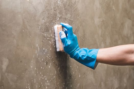 Cleaning the concrete wall.