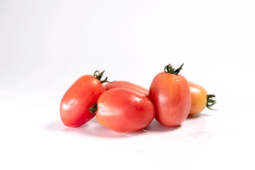 Closeup group of red tomatoes isolated on white background.