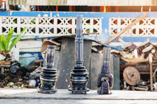 Front axle parts of 4 wheel drive pickup truck placed on the wooden table.