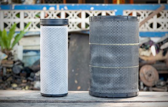 Old truck air filter placed on the wooden table.