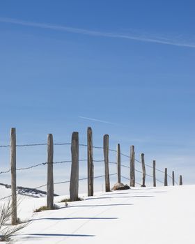 Snowy horizon with a fence. Copy space.