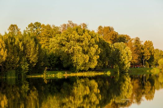 .View of the lakes in the park from the other side in the evening in autumn.