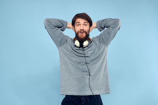 man wearing headphones music emotion lifestyle modern style technology blue background. High quality photo