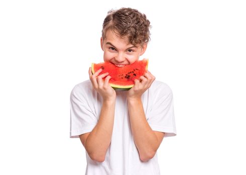Portrait of teen boy eating ripe juicy watermelon and smiling. Cute young teenager with slice healthy watermelon, isolated on white background.