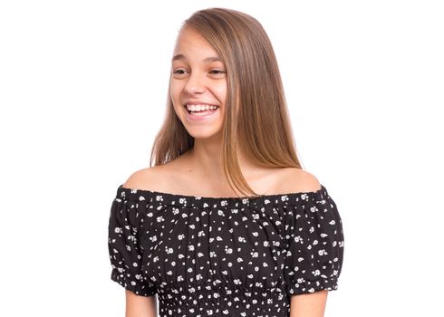 Beautiful teen girl smiling and looking away. Portrait of young pretty funny child, isolated on white background. Young happy teenager in studio.