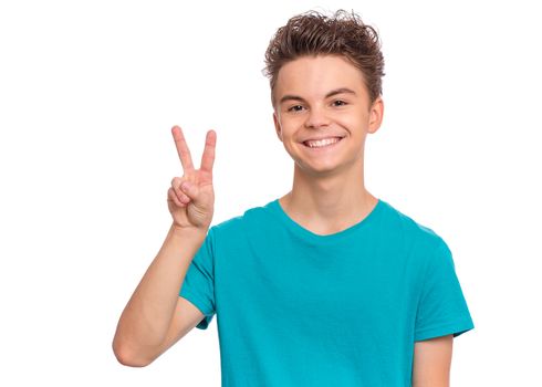 Portrait of handsome teen boy making Victory Gesture. Happy cute child isolated on white background.