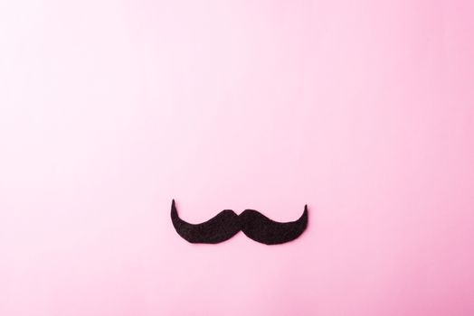 Black mustache paper, studio shot isolated on pink background, Prostate cancer awareness month, Fathers day, minimal November moustache concept
