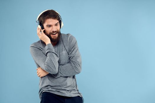 man wearing headphones music emotion lifestyle modern style technology blue background. High quality photo