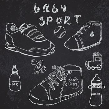 Baby shoes set sketch handdrawn on blackboard.