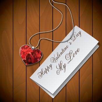 Letter with pendant on wood background.