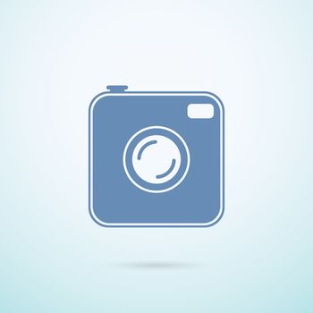 Old photocamera flat icon on blue background.