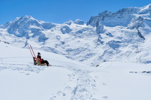 Young Woman Tourists see beautiful view of snow mountain Matterhorn peak, Zermatt, Switzerland.