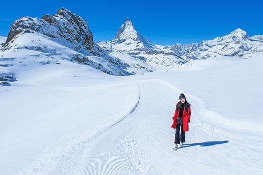 Young Woman Tourists see beautiful view of snow mountain Matterhorn peak, Zermatt, Switzerland.