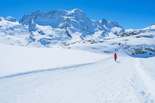 Young Woman Tourists see beautiful view of snow mountain Matterhorn peak, Zermatt, Switzerland.