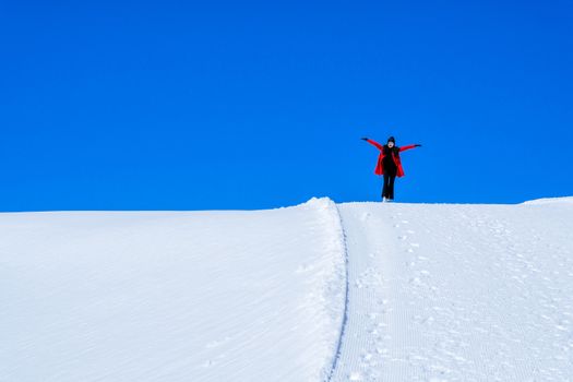 Young Woman Tourist walking in snow mountain Matterhorn peak, Zermatt, Switzerland.