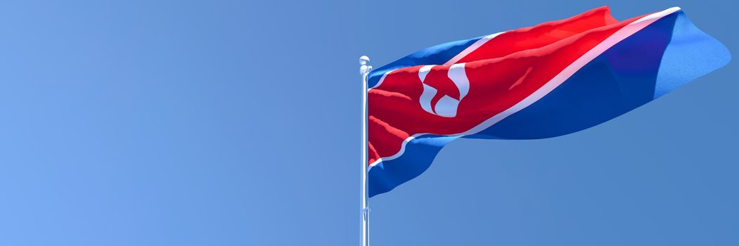 3D rendering of the national flag of North Korea waving in the wind against a blue sky