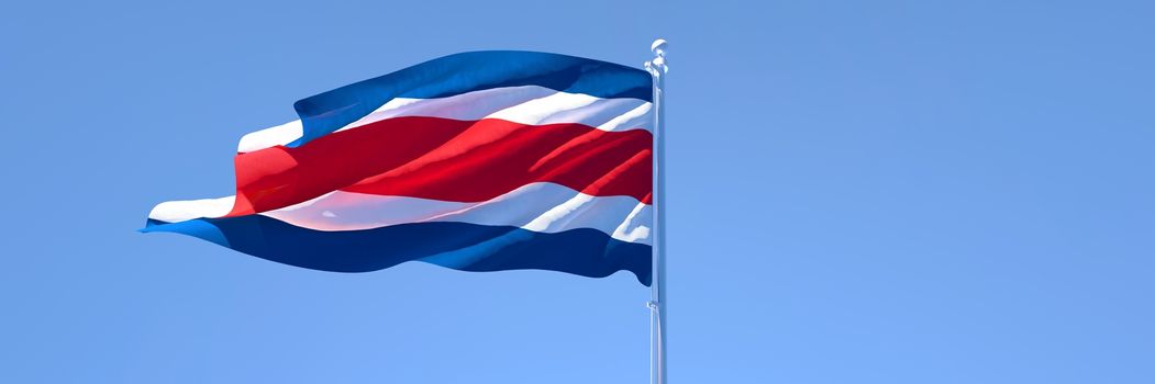 3D rendering of the national flag of Costa Rica waving in the wind against a blue sky