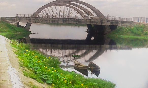 stylish concrete bridge on river with sky