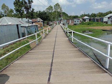 steel and wooden make bridge closeup on river