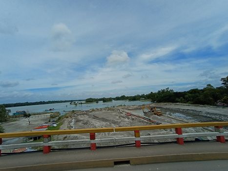 concrete bridge on river with sky