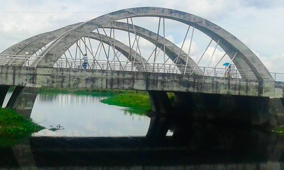 stylish concrete bridge on river with sky