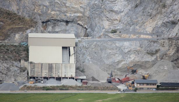 Stone quarry in Switzerland, heavy machinery working with heavy material