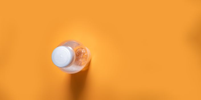 water bottle on orange background with copy space