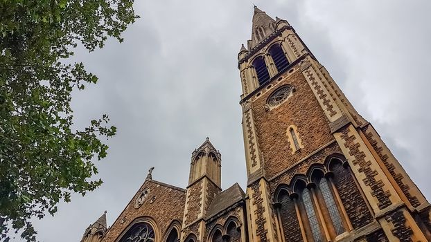 London, UK - July 8, 2020: Low angle shot of St. Matthew's church. Cloudy sky as a background.