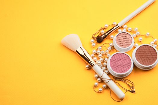 Eyeshadow eye makeup brush on yellow background top view Copy Space. High quality photo