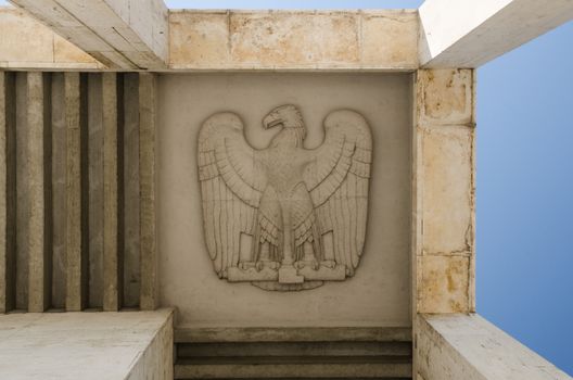 The eagle, symbol of the Roman legions, carved in relief on the ceiling of a colonnade of the EUR district in Rome
