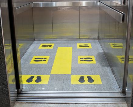 Marks for standing distance in passenger elevators To stand apart During the coronavirus outbreak. Concept of social distance