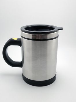 Self stirring mug made from aluminum metal with lid cover use to stir liquid content before drinking