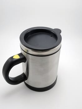 Self stirring mug made from aluminum metal with lid cover use to stir liquid content before drinking