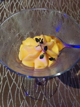 Yellow mango ice cream on glass serve in hotel restaurant