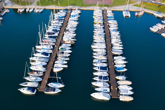 Aerial bird eye view of sailboats and yachts moored in Lovere port, Iseo lake near Bergamo,Italy.