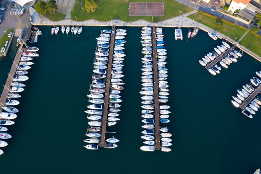 Aerial bird eye view of sailboats and yachts moored in Lovere port, Iseo lake near Bergamo,Italy.