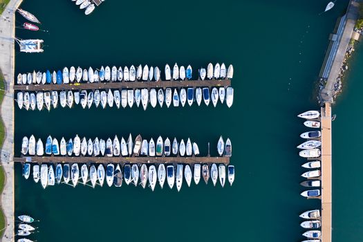 Aerial bird eye view of sailboats and yachts moored in Lovere port, Iseo lake near Bergamo,Italy.