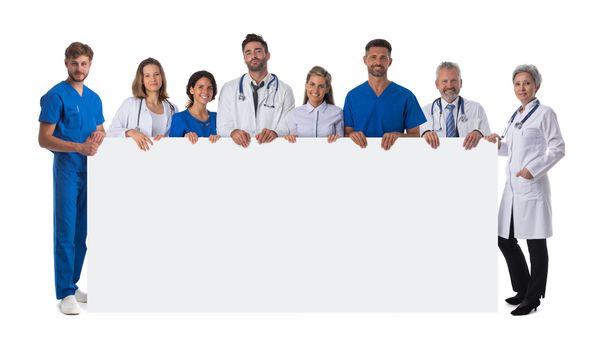 Group of happy multiracial doctors holding blank placard with copy space for text isolated on white background full length portrait