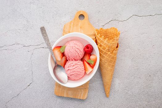 Strawberry  ice cream flavour in white  bowl setup on concrete background . Summer and Sweet menu concept.