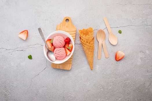 Strawberry  ice cream flavour in white  bowl setup on concrete background . Summer and Sweet menu concept.