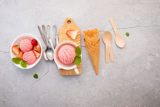 Strawberry  ice cream flavour in white  bowl setup on concrete background . Summer and Sweet menu concept.