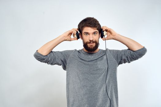 Man in headphones listens to music lifestyle leisure light background. High quality photo