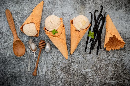 Vanilla ice cream flavor in cones with Vanilla pods setup on concrete background . Summer and Sweet menu concept.