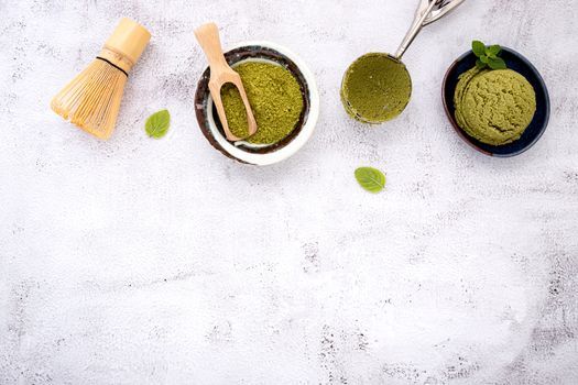 Matcha green tea ice cream with waffle cone and mint leaves  setup on white stone background . Summer and Sweet menu concept.