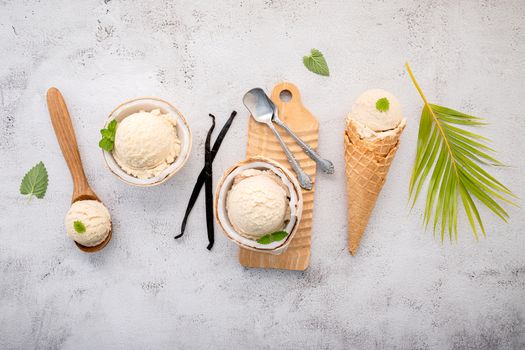 Coconut ice cream flavours in half of coconut setup on white stone background. Summer and Sweet menu concept.